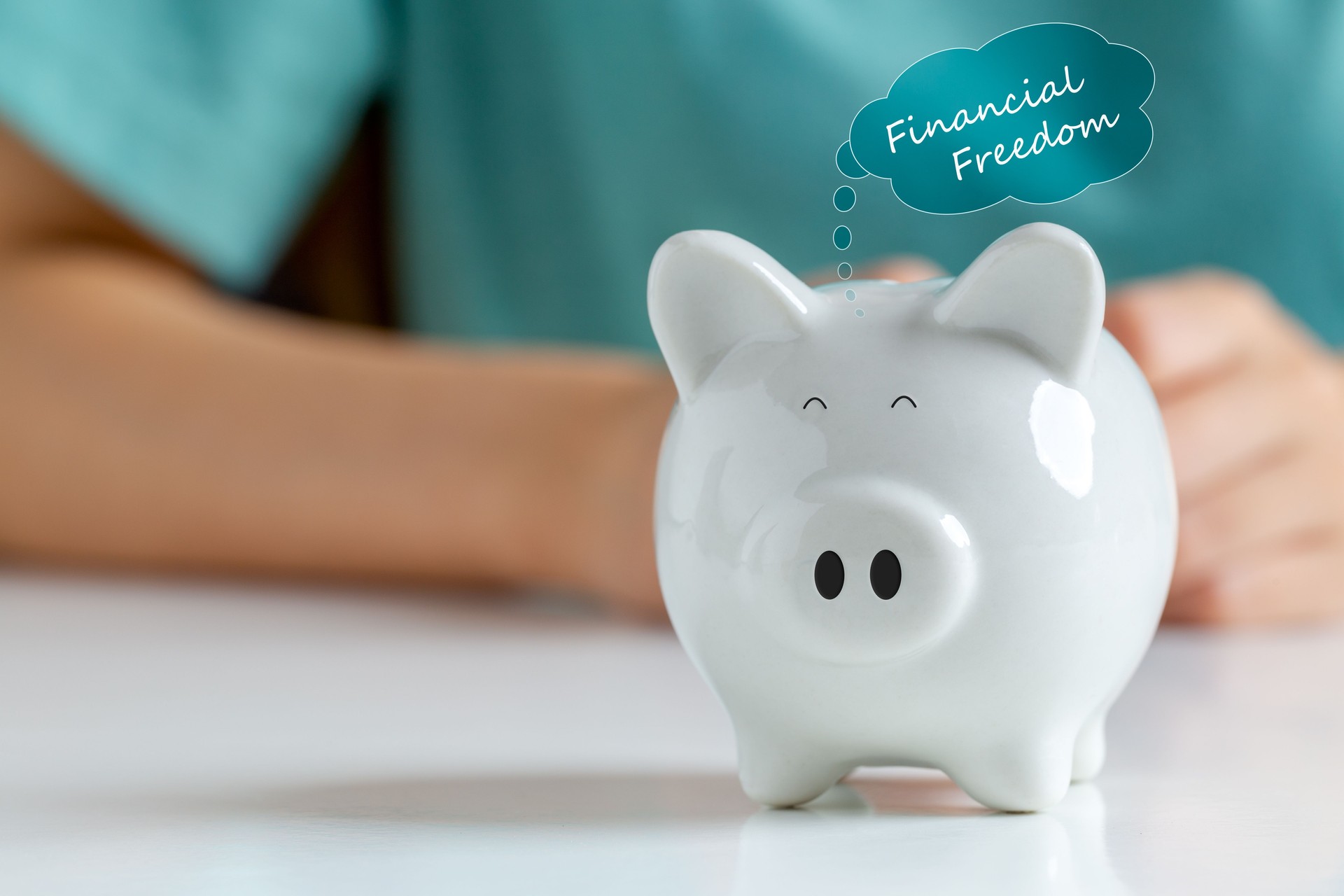 Happy smiley face piggy bank with text label "financial freedom"  Saving money for financial independence or financial freedom concept.